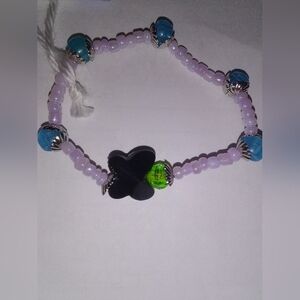 Handmade Purple Beaded Bracelet with Black Clover Accent